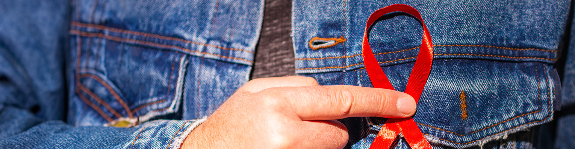 red ribbon pinned on a jean jacket