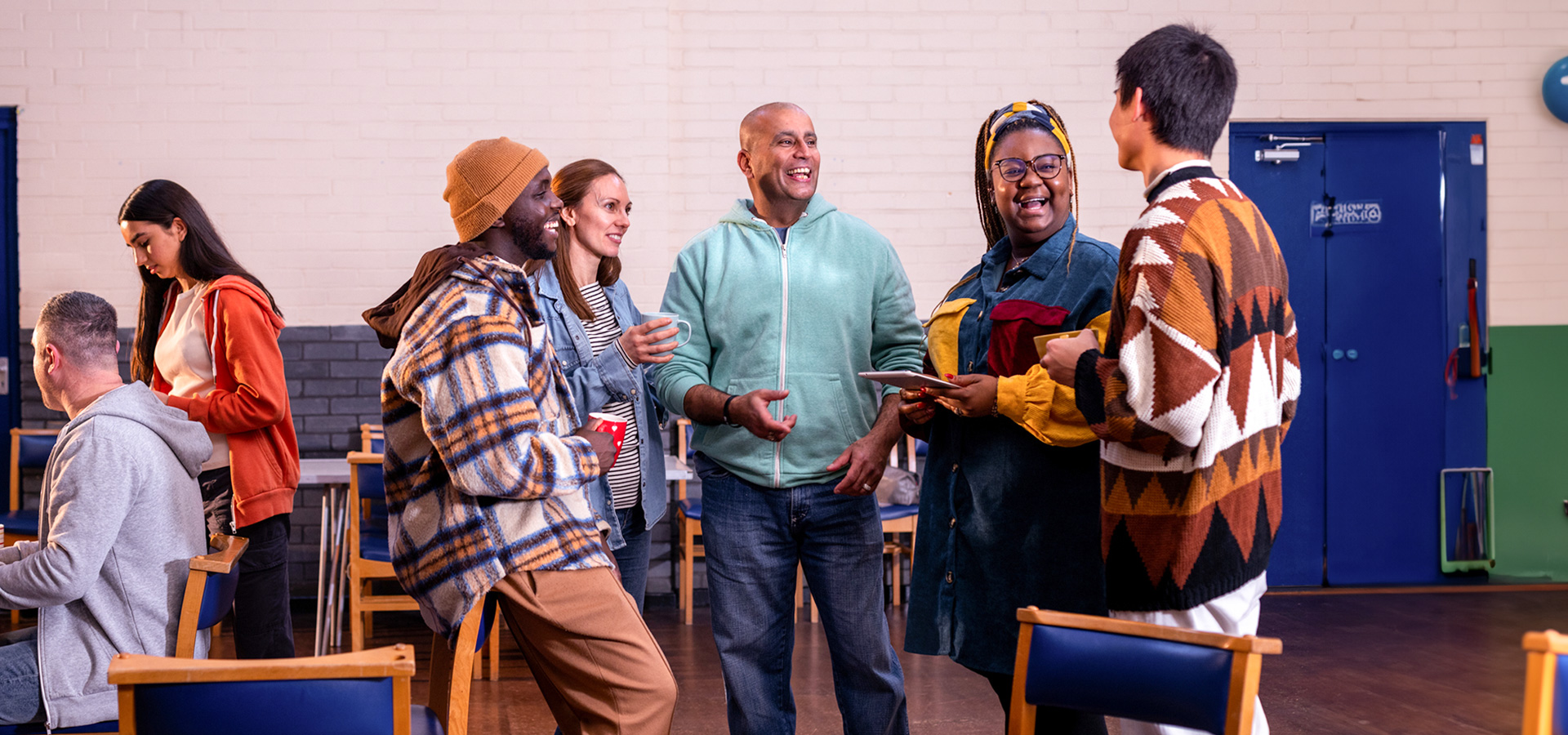 group of people smiling and talking in a gym center