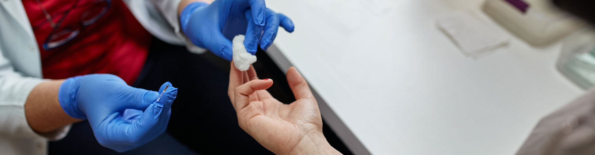 gloves taking a finger prick test